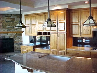 view of kitchen with natural wood custom cabinets by Alpine Cabinet Co