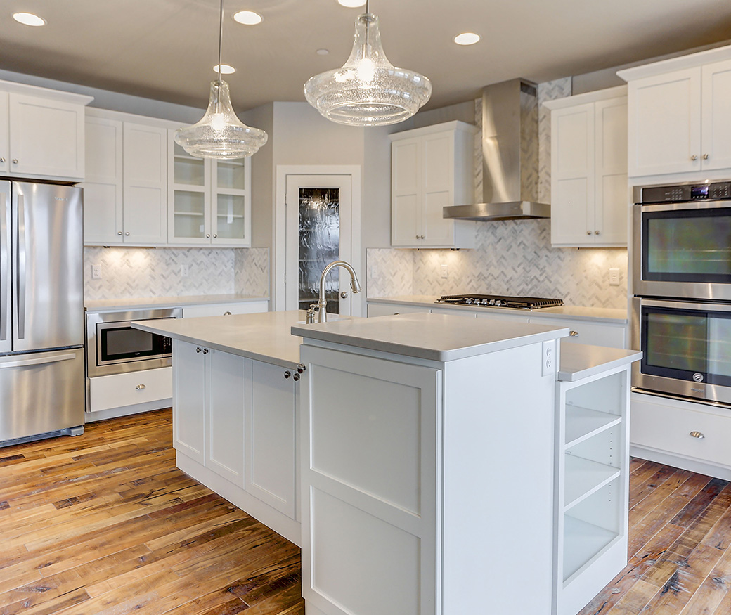 White Cabinets in kitchen with hardwood floors by Alpine Cabinet Co.